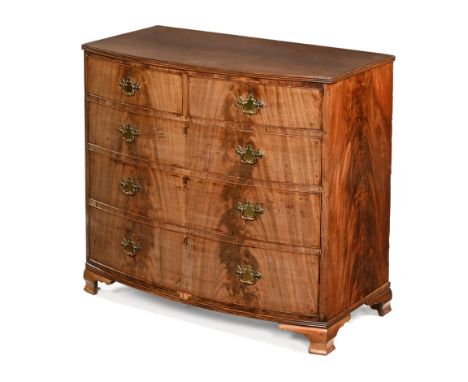 An early 19th century bowfronted chest of drawers, two short and three long with brass drop handles with shaped backplates an
