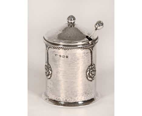 A planished silver preserve dish with glass liner by Albert Edward Jones, Birmingham 1923.  The spoon also planished and also