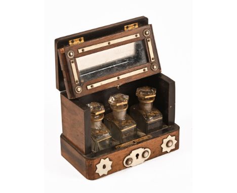 A Victorian walnut ivory mounted scent bottle case, of tantalus form containing three glass bottles.  NOTE:  Currently unlock