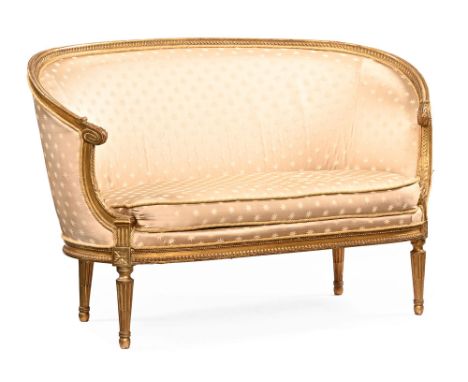 A French canape two seater sofa, with gilt showframe and upholstered in a gold starred material, raised on turned fluted legs