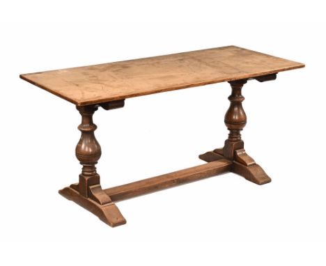 An oak refectory table, with plank top and bulbous turned supports with centre stretcher and sledge supports beneath.  Height