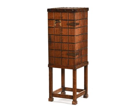 A Liberty & Co style Arts & Crafts oak floor standing smokers and drinks cabinet, with fitted interior, having a copper top a