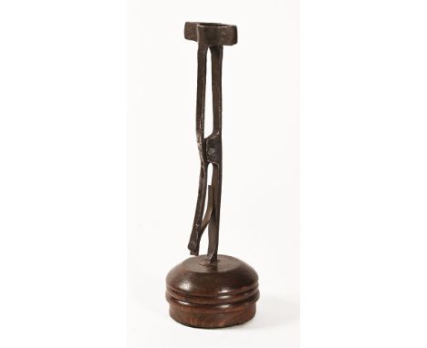 An 18th century rush light holder type device, raised on a later turned wooden stand.  Height 33.5 cm.