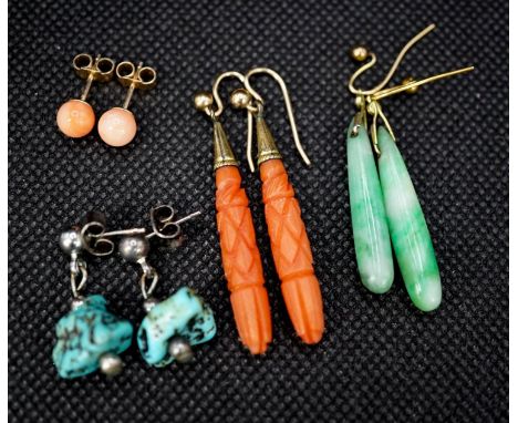 A pair of gilt metal and carved coral set teardrop shaped earrings, 38mm, a pair of similar shaped jade earrings and two othe