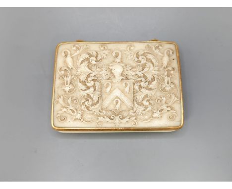 An early 19th century gold mounted ivory armorial table snuff box, 8.3 cmthe top carved with an armorial with helm surmount (