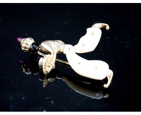 A 20th century Viennese 585 yellow metal, black enamel, mother of pearl and cabochon set brooch, modelled as a Blackamoor, 41