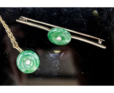 A yellow metal mounted jade and diamond set circular pendant, 14mm, on a 585 rope twist chain and a similar jade and diamond 