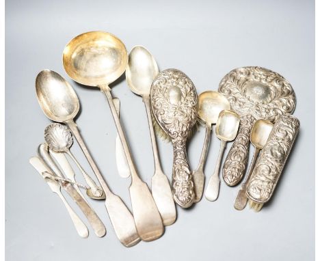 A group of silver flatware including a Victorian soup ladle and two basting spoons and three dressing table accessories, weig