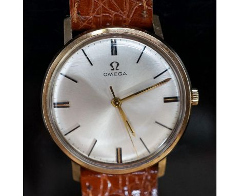 A gentleman's yellow metal Omega manual wind wrist watch, on associated leather strap, with engraved inscription, case diamet