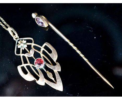 An Art Nouveau yellow metal and garnet set pendant,39mm, on a 9ct chain and a garnet and split pearl set stick pin, gross wei