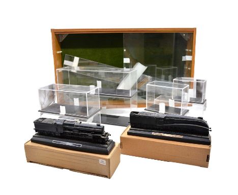 A wooden wall display with glass window, width 78cm, height 44cm, with eight display boxes and two coal model locomotives 'Ma