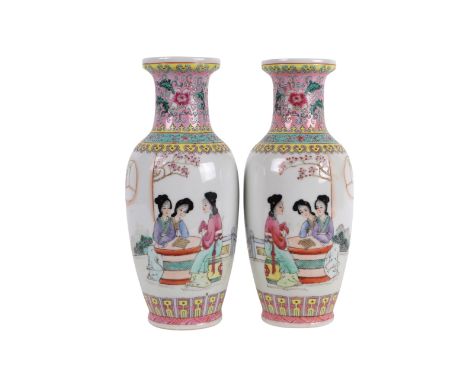 A pair of Chinese famille rose Republic style baluster vases decorated with figures, red seal mark to the underside. 25cm hig