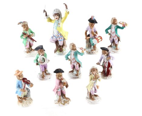 A Sitzendorf style porcelain monkey band including trumpeters, conductor, violinist, French horn player and others, the large