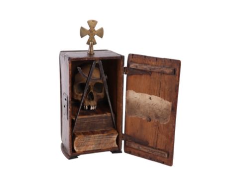Masonic interest:  A memento mori comprising a fragment in the form of a human skull mounted on half books within a wooden ca