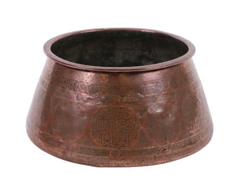 An impressive Islamic copper bowl decorated with calligraphy, 56cm diameter.