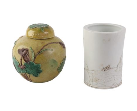 A blanc de chine cylindrical brush pot decorated with a musician seated in a garden, with calligraphy, impressed seal mark to