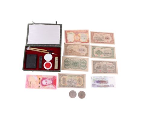 A quantity of Asian banknotes and coins to include Chinese, Vietnamese and Venezuelan examples; together with a cased Chinese