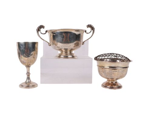 An Edwardian silver twin-handled trophy cup, Birmingham 1910, with presentation inscription, 415g; together with two other si
