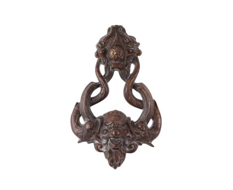 A large cast door knocker with mythical beast mask and dolphins, 23cms high.
