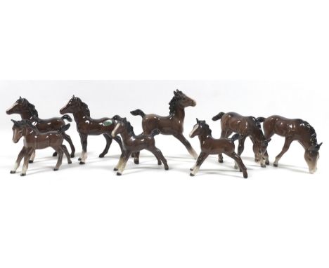 A group of eight Beswick foals, including 'Foal (Large, stretched), First Version, model 836, brown - gloss, 12.7cm high, two