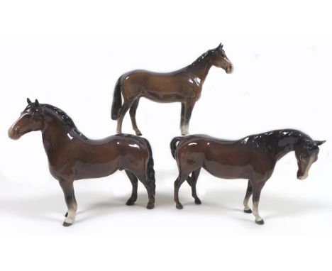 A group of three Beswick horses, including 'Mare (Facing right, head down)', model 1812, brown - gloss, 14.6cm high, 'Welsh C