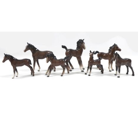 A group of seven Beswick foals and young horses, including 'Foal (Small, stretched, facing left)', model 997, brown - gloss, 