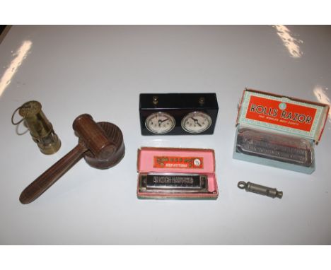 A box containing a gavel; a miniature mining lamp; The Metropolitan Whistle, Rolls razor; German harmonica with original box 