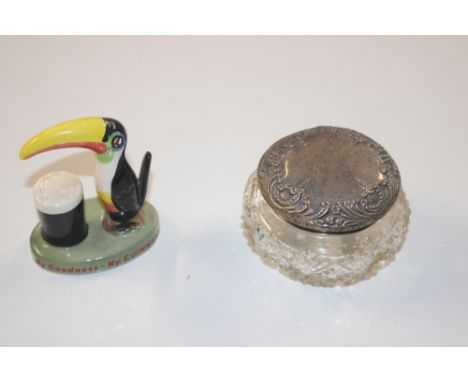 A silver topped dressing table jar and a Carlton ware Guinness advertising figure 