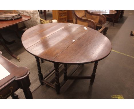 An antique oak gate leg dining table 