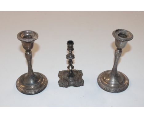 A pair of silver candlesticks with weighted bases  AF; and one other silver candlestick