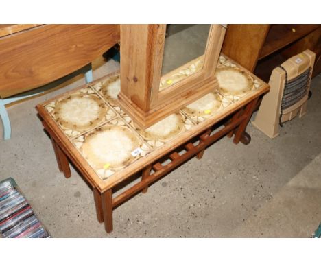 A teak and tile topped nest of three occasional tables 