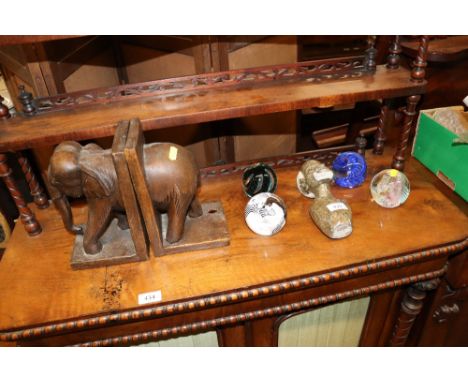 Four glass paperweights; bookend in the form of an elephant; and a soapstone bust