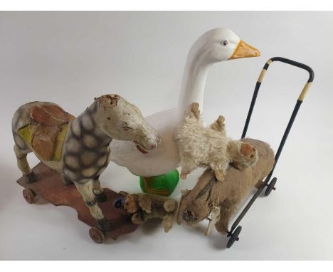 A collection of four vintage toys including Union Products Gladys Goose, a monkey playing cymbals and two push along toys 