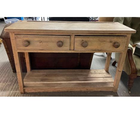 A Victorian pine dresser base with a two single drawers and single shelf below, 83cm high, 128cm long, 43cm wide