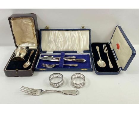 A cased silver egg cup and spoon set, a cased silver fork and spoon set, a cased silver knife, fork and spoon set (the knife 