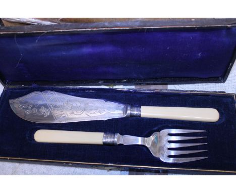 A cased fish and fork set with hallmarked silver collars 