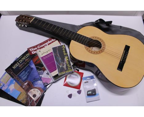 A cased Hohner acoustic guitar model MC-05, with a assorted guitar related books, strings and tuner, shipping unavailable 