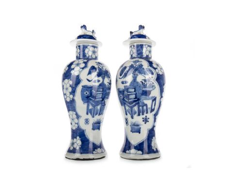 PAIR OF CHINESE BLUE AND WHITE VASES, 19TH CENTURY each decorated with a scene of flowers and planters, surrounded by prunus 