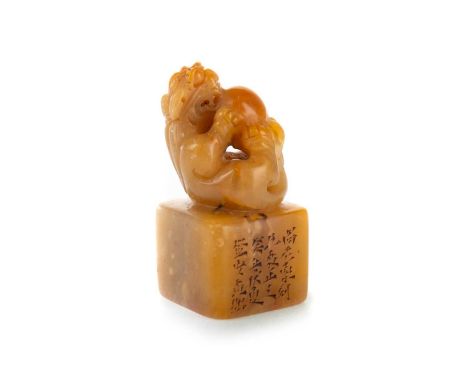 CHINESE SOAPSTONE SEAL, 20TH CENTURY modelled as a Foo Dog playing with a ball, on a raised square base, carved with Chinese 