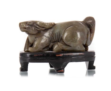CHINESE JADE FIGURE OF A WATER BUFFALO, 20TH CENTURY posed in a resting position, on hardwood stand9cm long