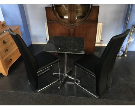 A granite top table and two chairs