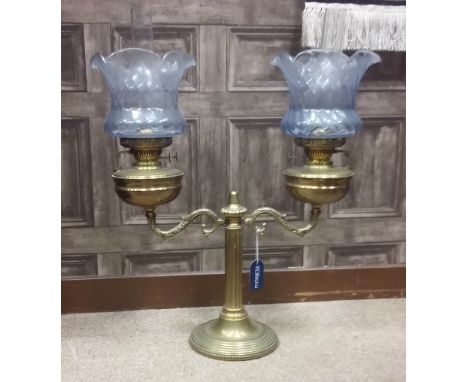 VICTORIAN BRASS DOUBLE OIL LAMP
with two scrolling branches issuing from a central fluted column, 70cm high