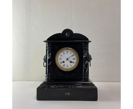 A 19th century French slate mantle clock having a shaped and engraved pediment over the central egg and dart brass mounted en