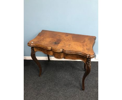 A Victorian mahogany console table with flip top card table top. Styled on Cabriole legs. Measures 74.5cm in height. 