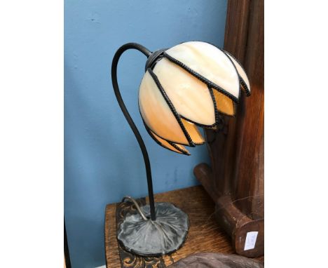A Tiffany style lamp, designed with a lily pad base. Working 