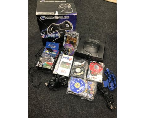 A Sega Saturn console, Loose games and boxed games, 2 Controllers and steering wheel. 