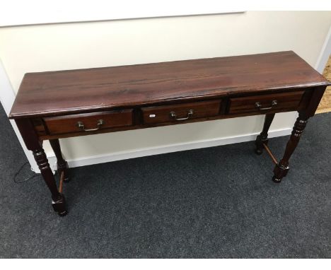 A Long hardwood console table fitted with 3 drawers. Measures 75x142x35cm 