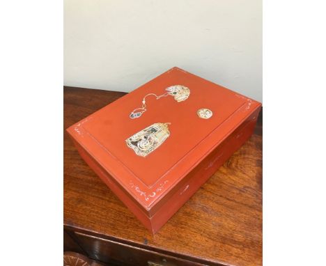 An Oriental red lacquered document box. Detailed with mother of pearl inlays. Measures 12x40x31xm 