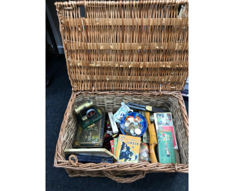 A Wicker hamper basket filled with collectables which includes old advertising tins, Joiners vintage planes, Old steam engine