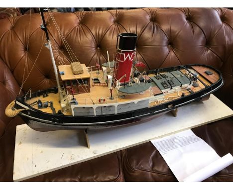 A Large hand made tug boat model. Highly detailed. displayed on a wooden display stand. made by Robert Henry Walker (1933-201